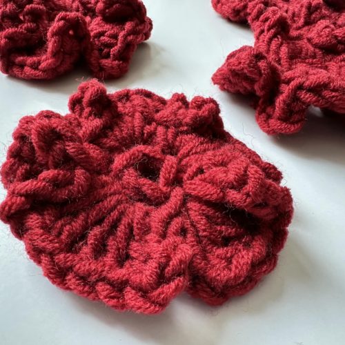 Kwiaty na szydełku burgundowe bordowe na sweter na szydełku z włóczkim burgundowe dodatki jesien 2025 modne burgundowy sweter z kwiatami burgundowe stylizacje